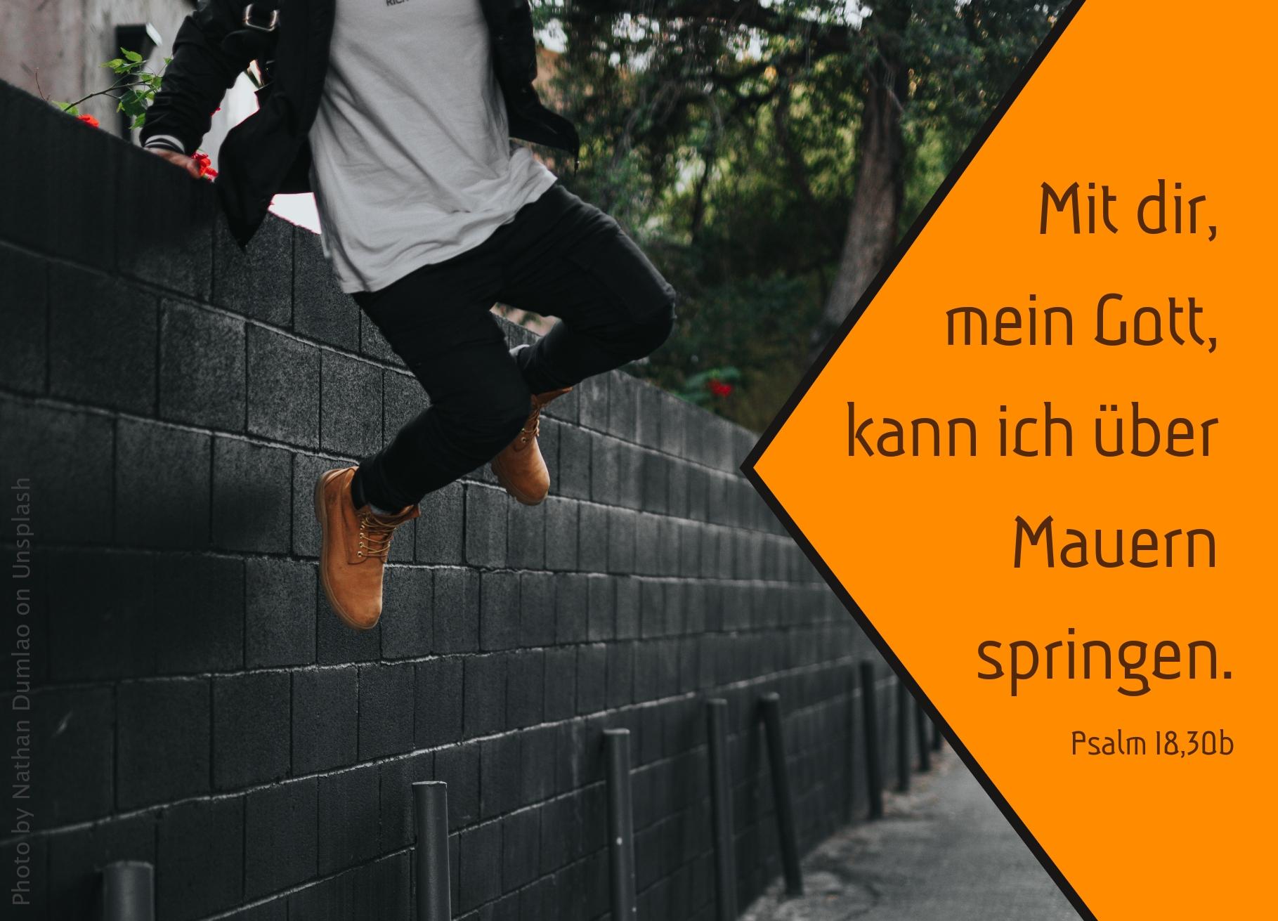 Person springt über Mauer